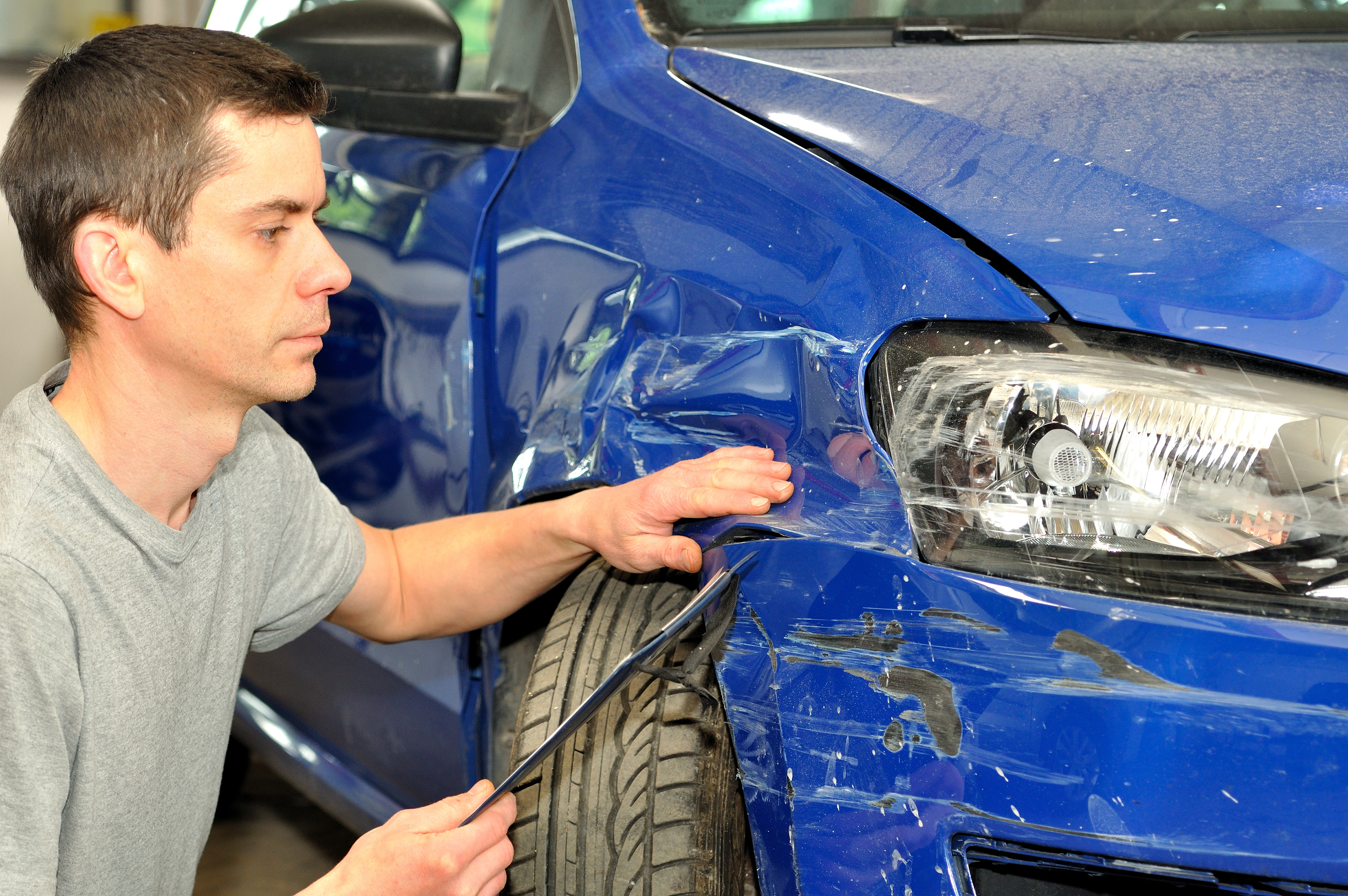 Man inspecting damaged car